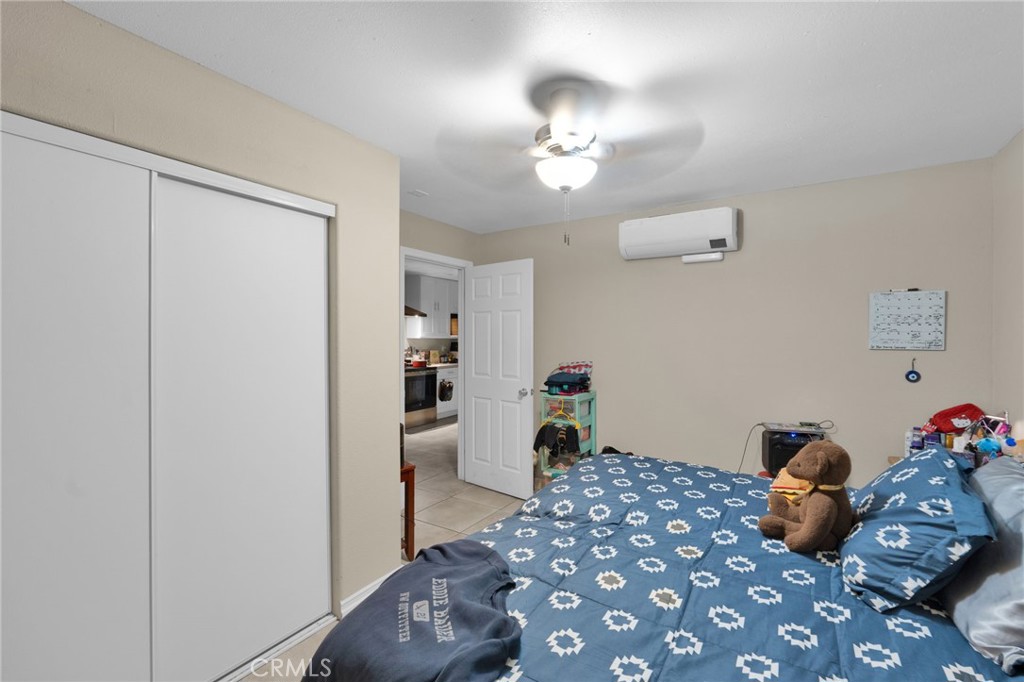 12865 Barbet Road Phelan, CA 92371 - Photo 39 of 51 a bedroom with a bed and wooden floor