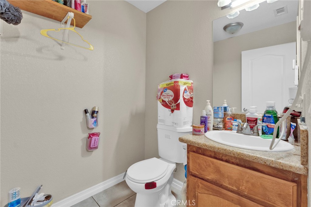 12865 Barbet Road Phelan, CA 92371 - Photo 44 of 51 a bathroom with a sink mirror vanity and toilet