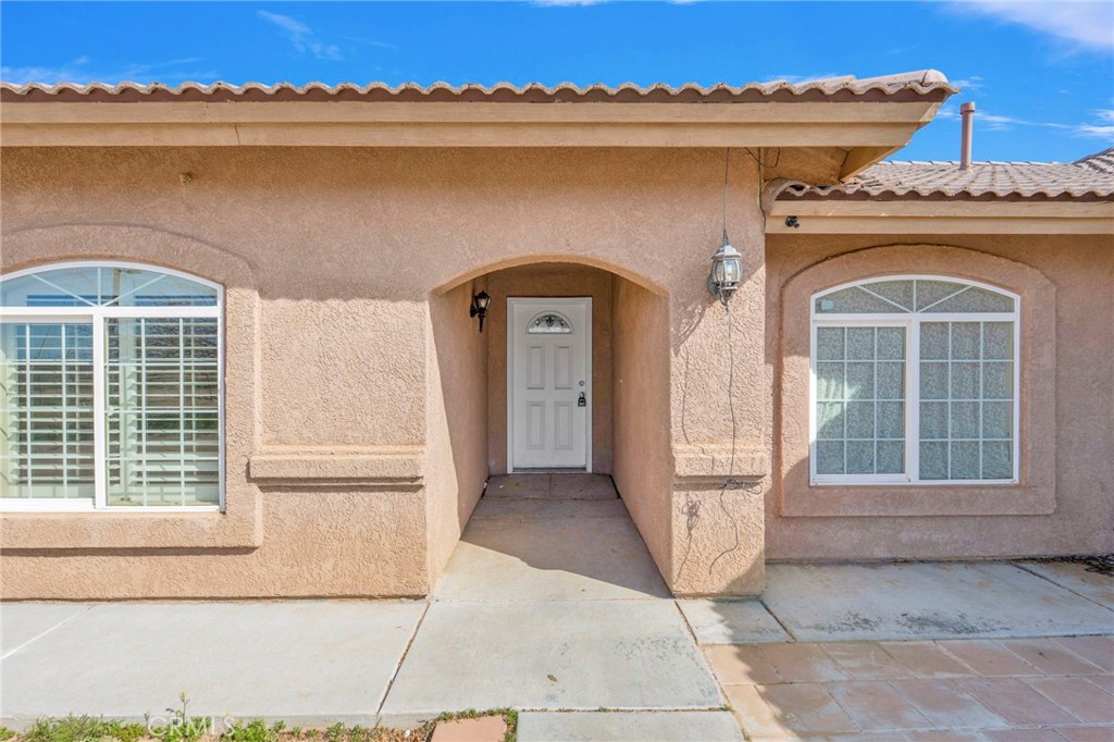 12865 Barbet Road Phelan, CA 92371 - Photo 5 of 51 a front view of a house with large windows
