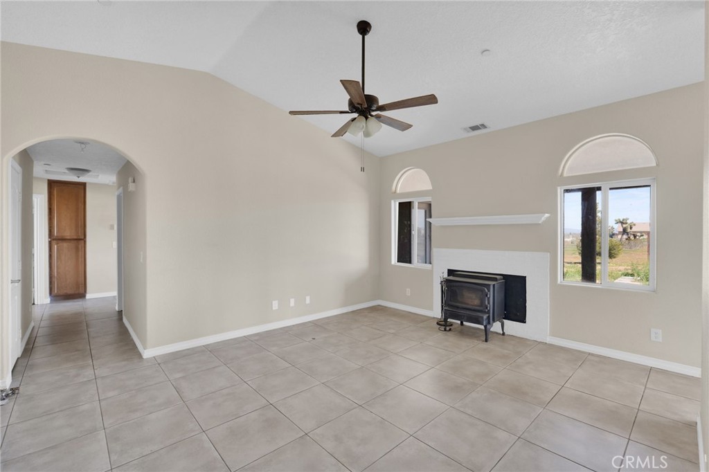 12865 Barbet Road Phelan, CA 92371 - Photo 9 of 51 a view of a livingroom with a chair and a ceiling fan