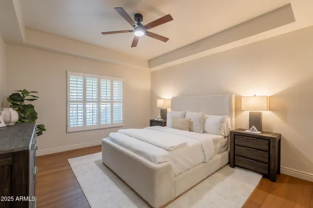 a bedroom with a large bed and a chandelier