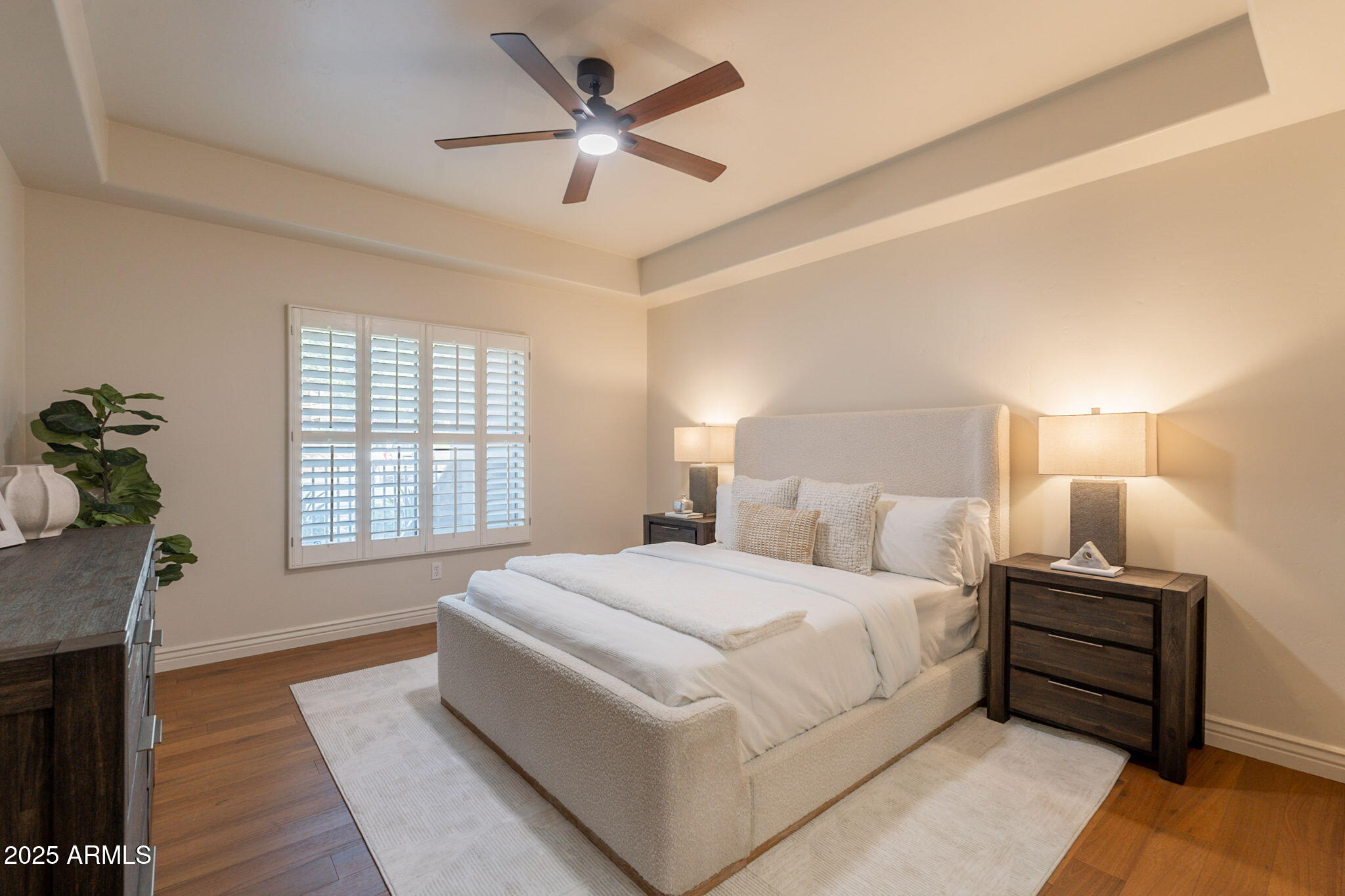 5450 East Deer Valley Drive, Unit 1208 Phoenix, AZ 85054 - Photo 12 of 36 a bedroom with a large bed and a chandelier