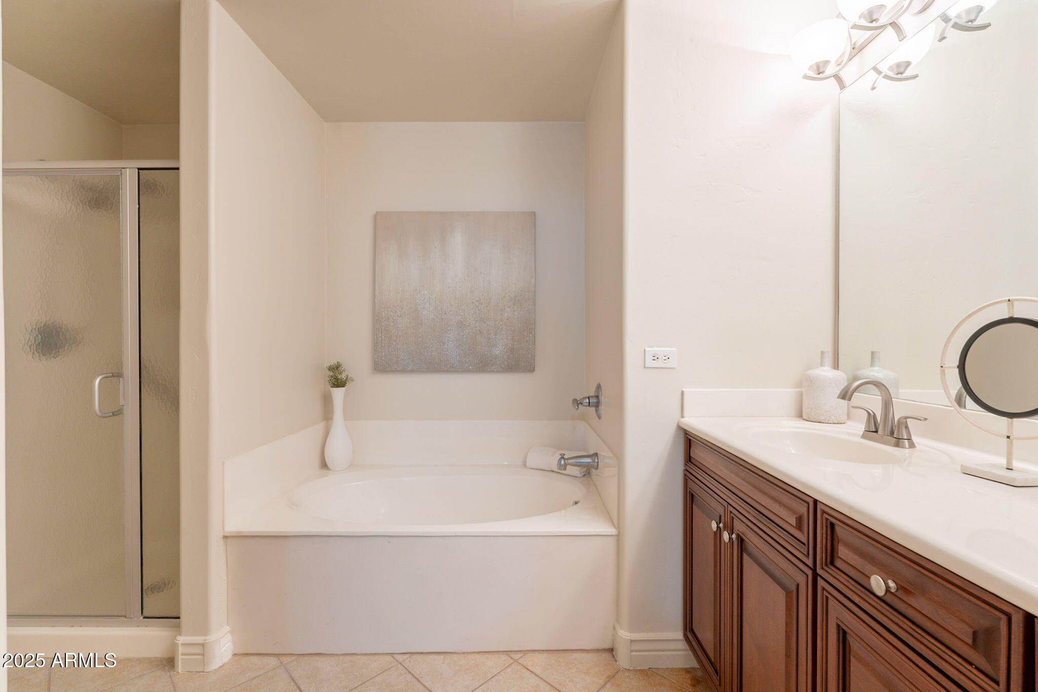 5450 East Deer Valley Drive, Unit 1208 Phoenix, AZ 85054 - Photo 15 of 36 a bathroom with a tub sink and mirror