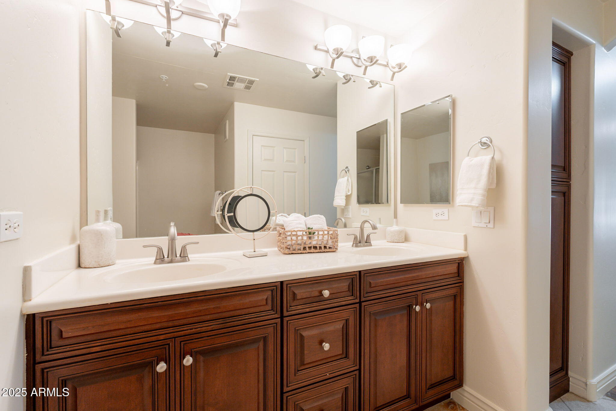 5450 East Deer Valley Drive, Unit 1208 Phoenix, AZ 85054 - Photo 16 of 36 a bathroom with a double vanity sink and a mirror