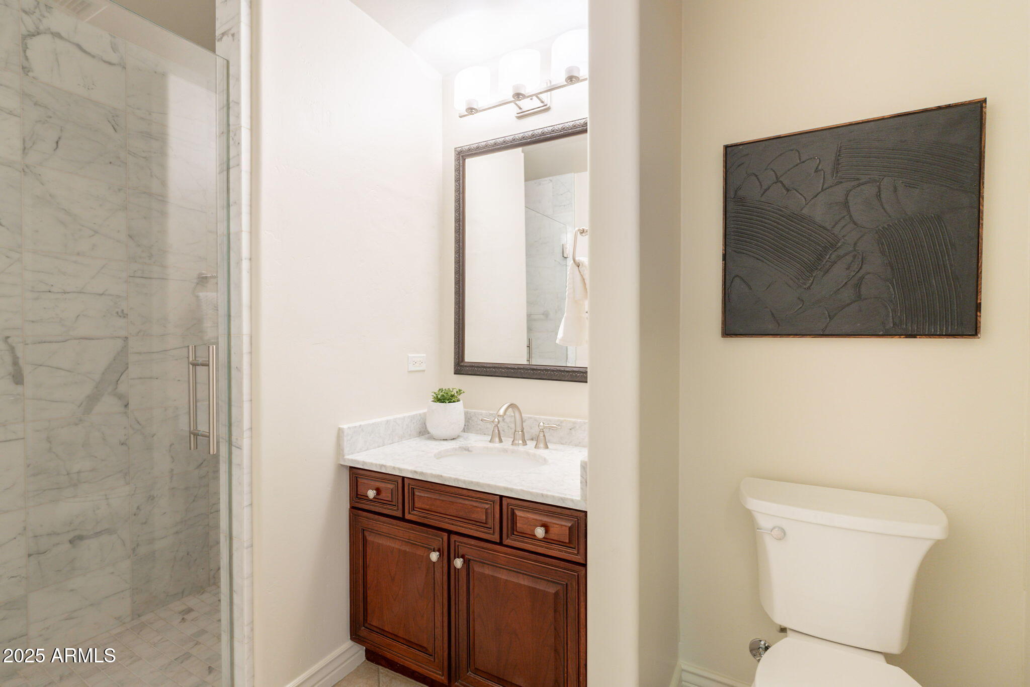 5450 East Deer Valley Drive, Unit 1208 Phoenix, AZ 85054 - Photo 19 of 36 a bathroom with a sink and a mirror with toilet