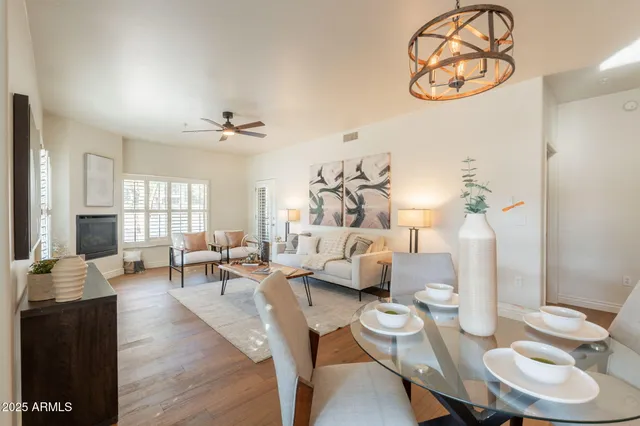 a living room with furniture and wooden floor