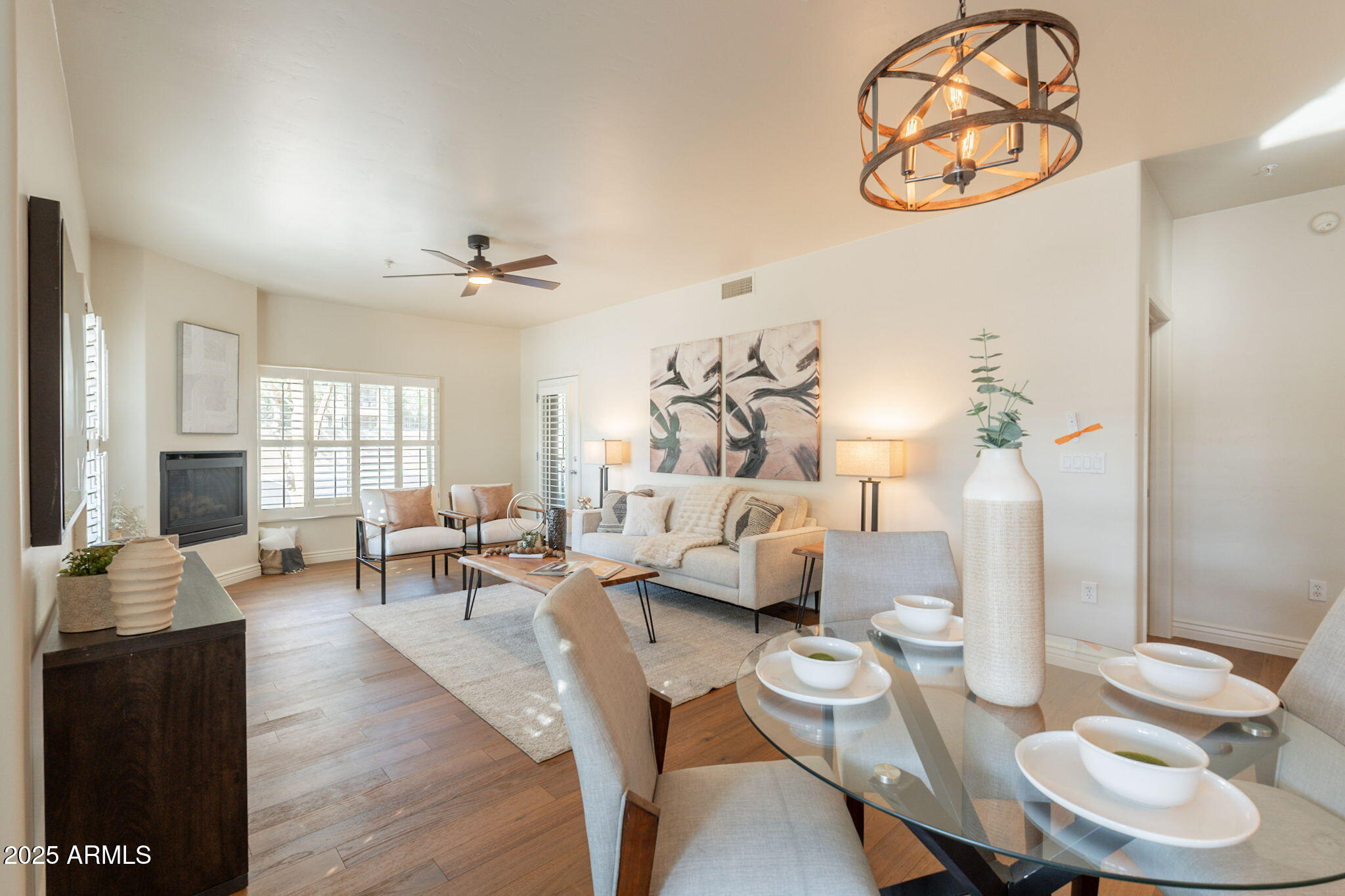 5450 East Deer Valley Drive, Unit 1208 Phoenix, AZ 85054 - Photo 2 of 36 a living room with furniture and wooden floor
