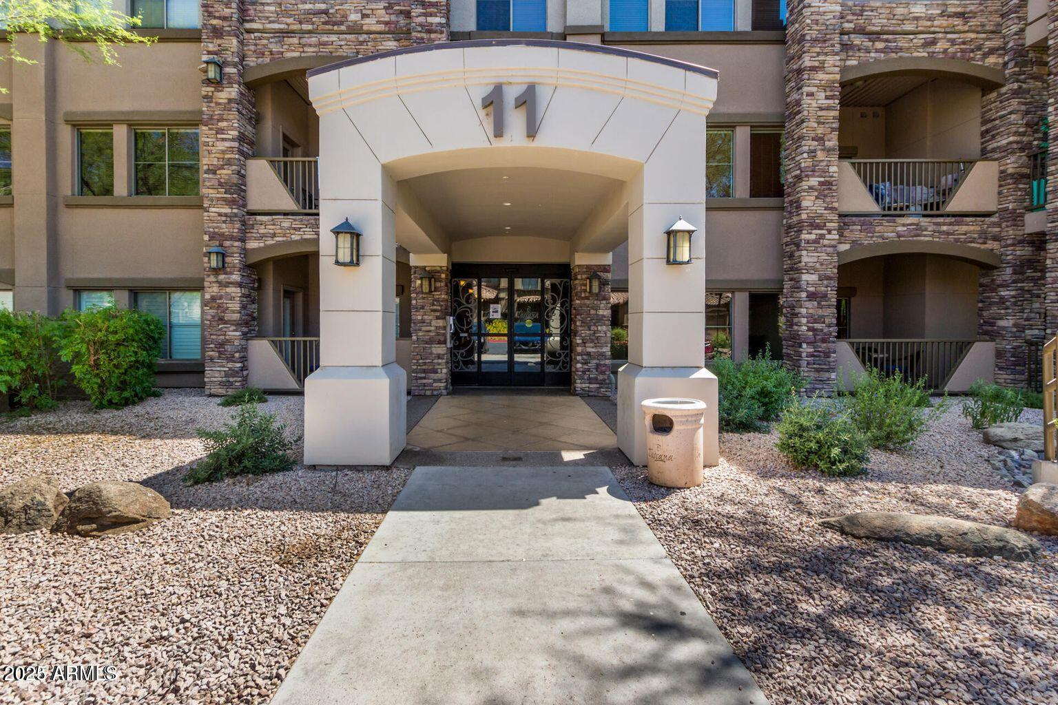 5450 East Deer Valley Drive, Unit 1208 Phoenix, AZ 85054 - Photo 35 of 36 a front view of a house with garden