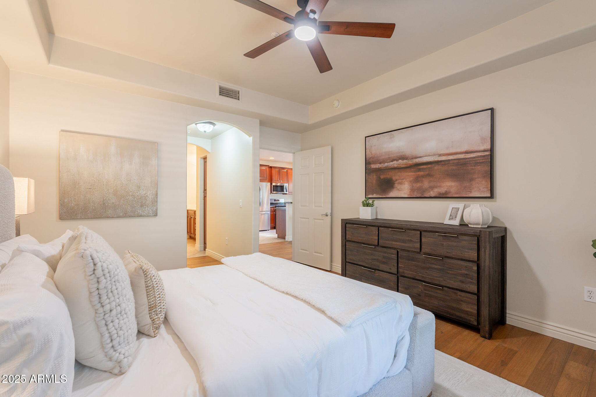 5450 East Deer Valley Drive, Unit 1208 Phoenix, AZ 85054 - Photo 5 of 36 a bedroom with a bed and a chandelier