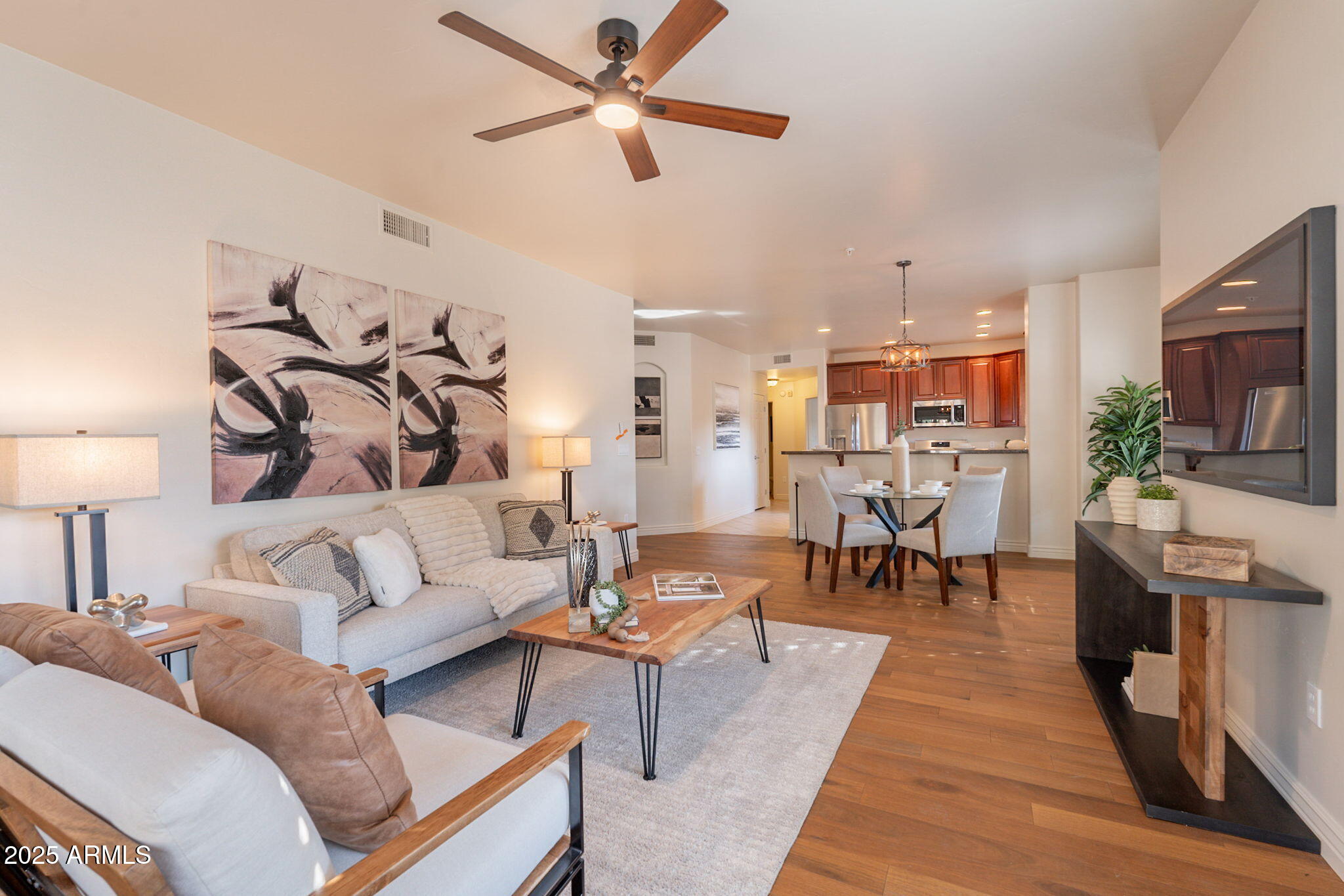 5450 East Deer Valley Drive, Unit 1208 Phoenix, AZ 85054 - Photo 6 of 36 a living room with furniture and a wooden floor