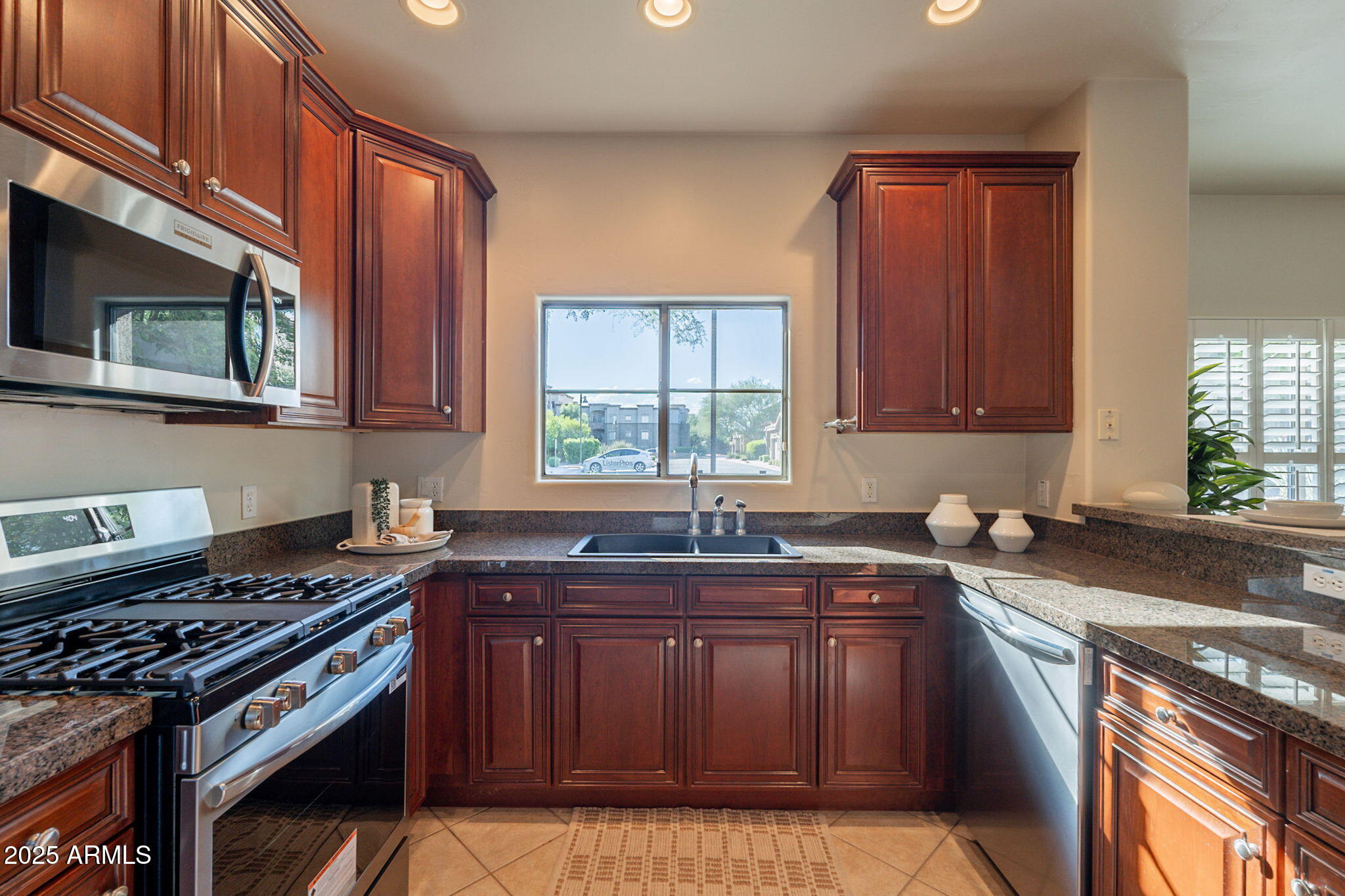 5450 East Deer Valley Drive, Unit 1208 Phoenix, AZ 85054 - Photo 8 of 36 a kitchen with a sink stove top oven and cabinets