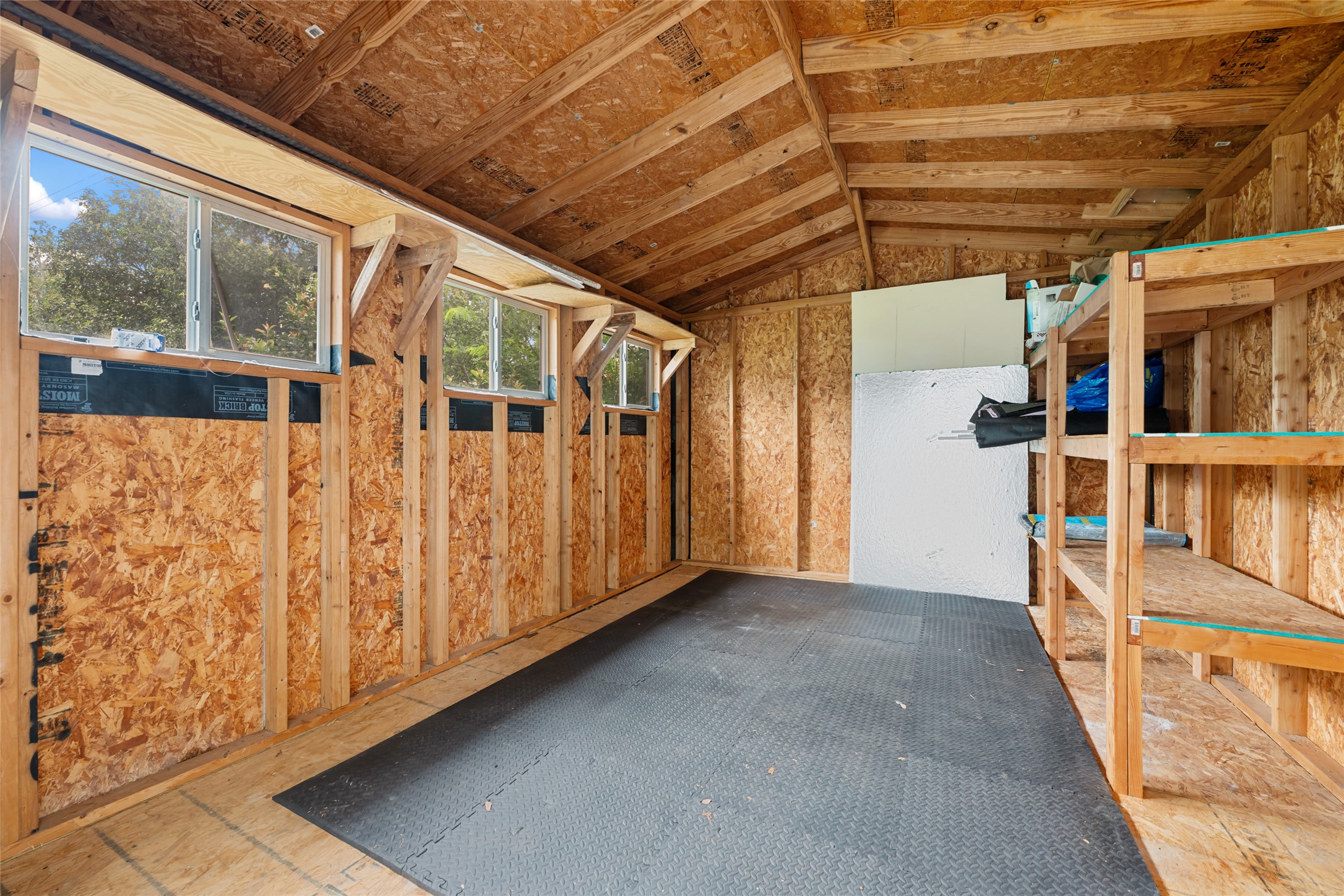 4602 Frontier Trail Austin, TX 78745 - Photo 20 of 21 A utilitarian shed offers ample storage and natural light for various uses.