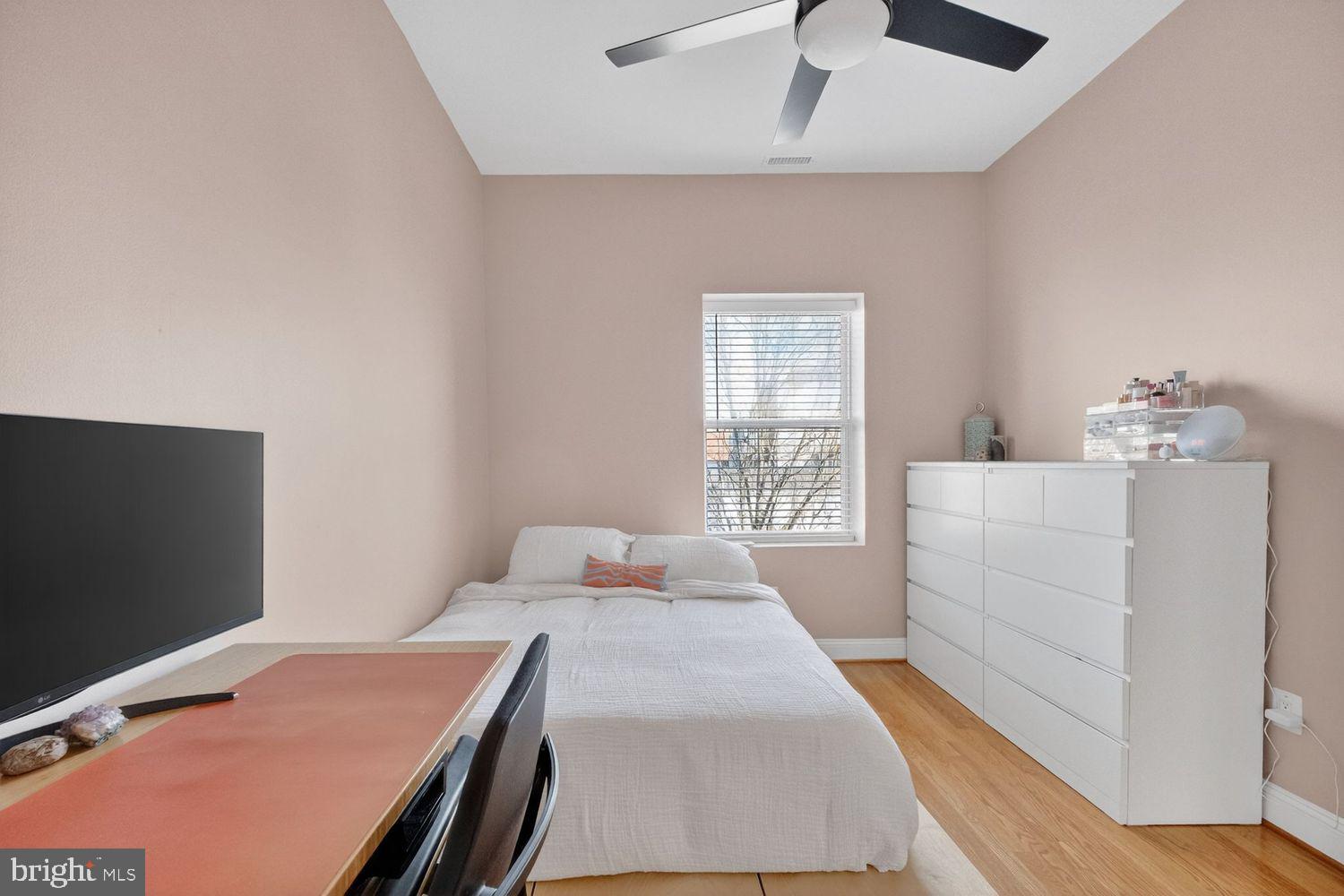 219 T Street Northeast, Unit 404 Washington, DC 20002 - Photo 11 of 24 a bedroom with a bed and a flat tv screen