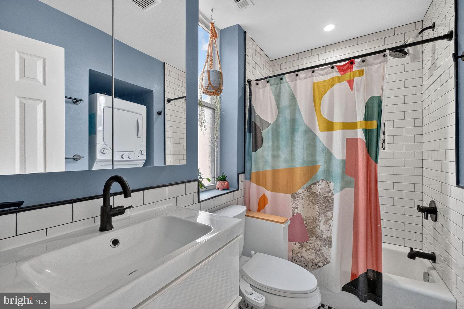 219 T Street Northeast, Unit 404 Washington, DC 20002 - Photo 14 of 24 a bathroom with a sink toilet and shower