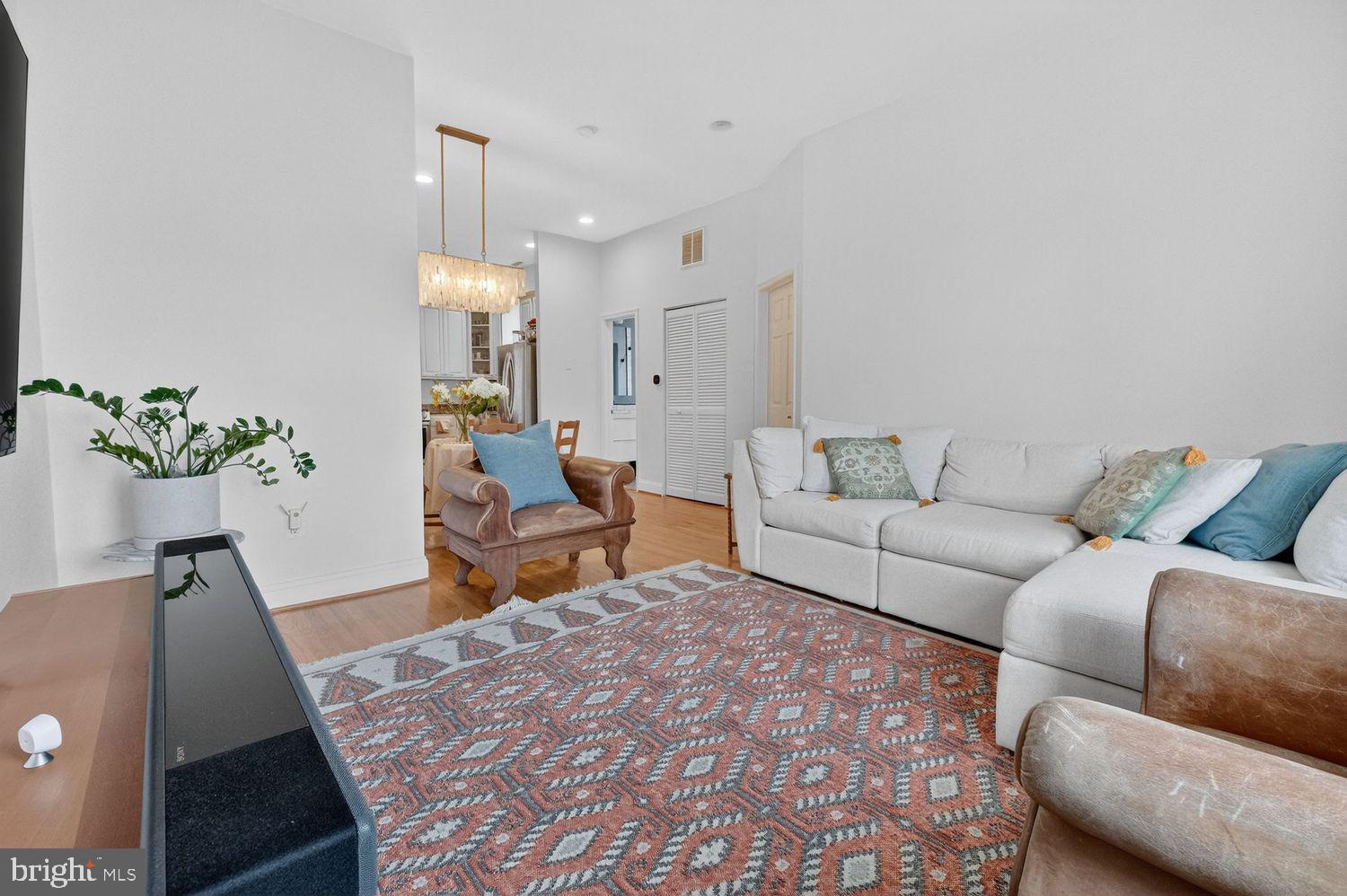 219 T Street Northeast, Unit 404 Washington, DC 20002 - Photo 4 of 24 a living room with furniture and a chandelier