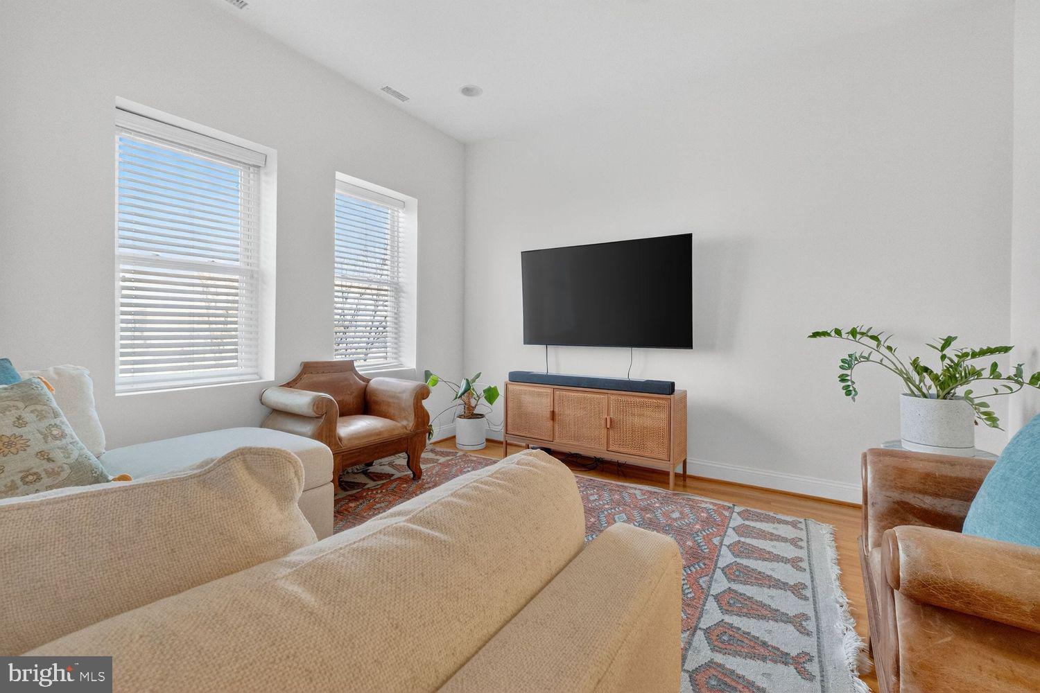 219 T Street Northeast, Unit 404 Washington, DC 20002 - Photo 5 of 24 a living room with furniture and a flat screen tv