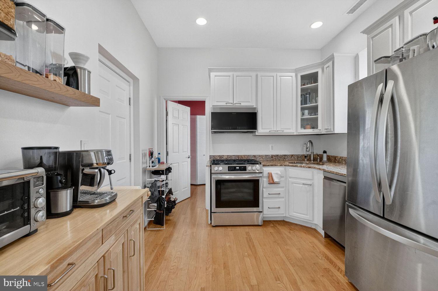 219 T Street Northeast, Unit 404 Washington, DC 20002 - Photo 7 of 24 a kitchen with stainless steel appliances a stove refrigerator sink and microwave