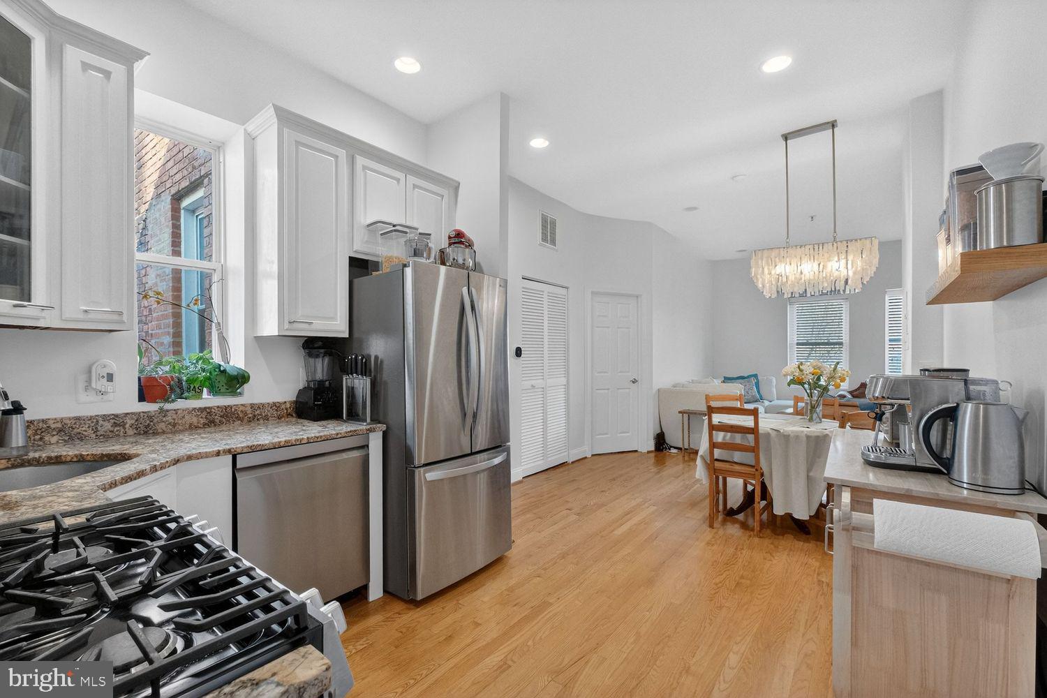 219 T Street Northeast, Unit 404 Washington, DC 20002 - Photo 8 of 24 a kitchen with stainless steel appliances a refrigerator and a stove top oven