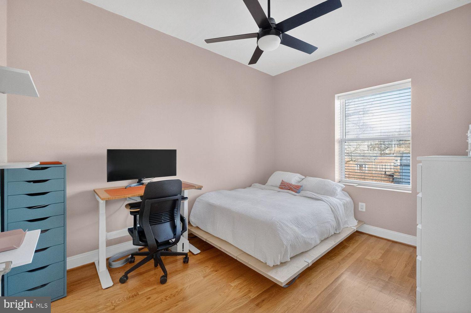219 T Street Northeast, Unit 404 Washington, DC 20002 - Photo 10 of 24 a bedroom with a bed and a desk
