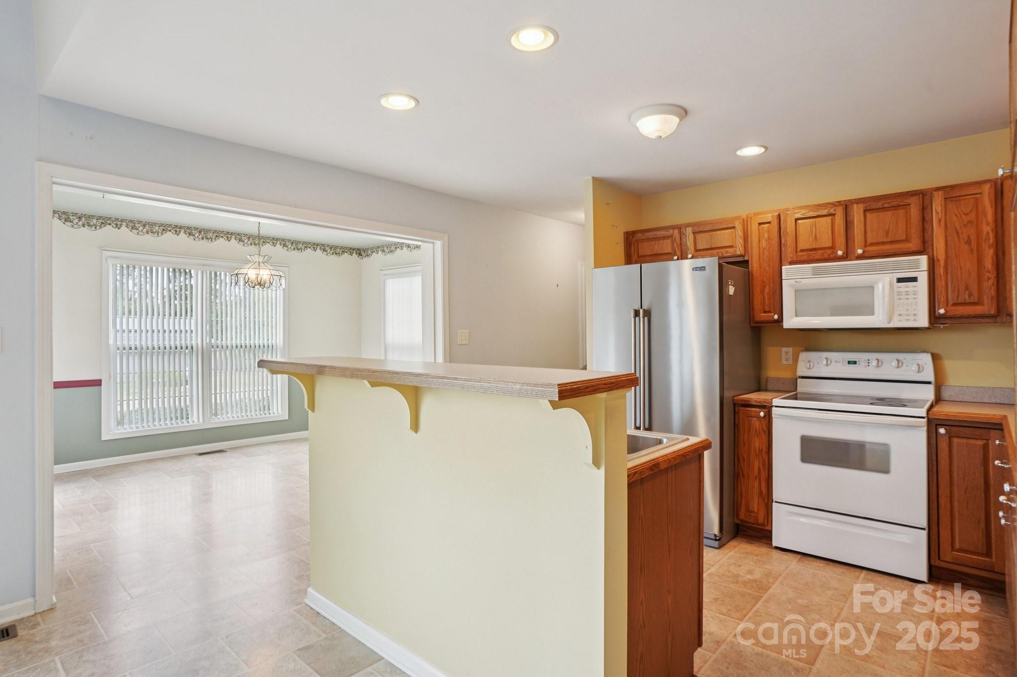 325 North Moose Road Mount Pleasant, NC 28124 - Photo 12 of 28 a kitchen with stainless steel appliances a refrigerator and a stove top oven