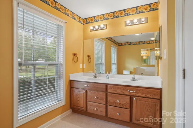 a bathroom with a granite countertop sink mirror and