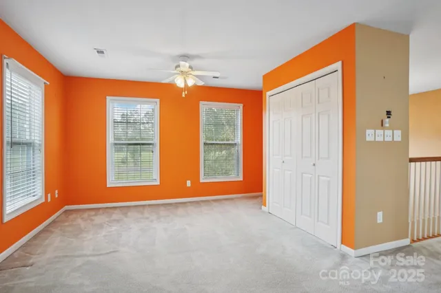 an empty room with windows and closet