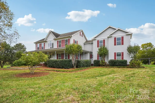 a front view of house with yard and green space
