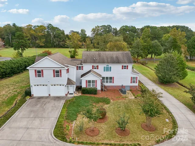 a aerial view of a house with a yard