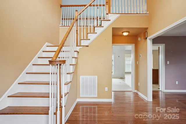 a view of entryway and hall with wooden floor