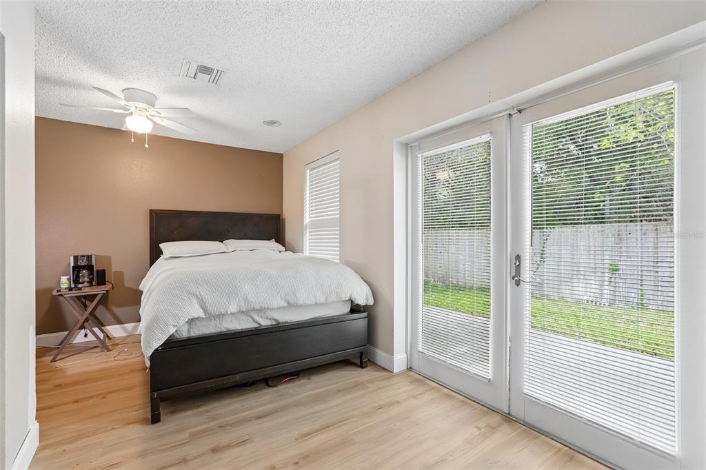 1525 Kestrel Way Brandon, FL 33511 - Photo 20 of 48 a bed sitting in a spacious bedroom next to a window