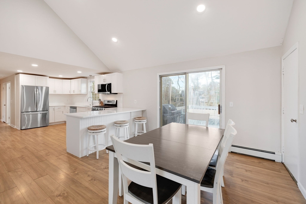 29 Butternut Circle Barnstable, MA 02635 - Photo 14 of 38 a view of a dining room with furniture and wooden floor