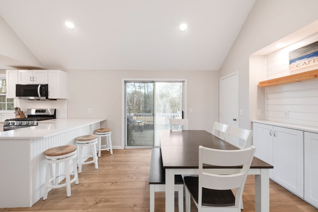 29 Butternut Circle Barnstable, MA 02635 - Photo 10 of 38 a kitchen with a dining table chairs and refrigerator