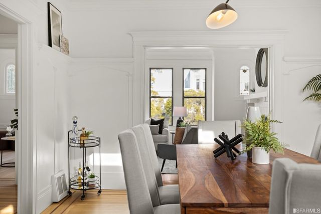 a living room with furniture and floor to ceiling window