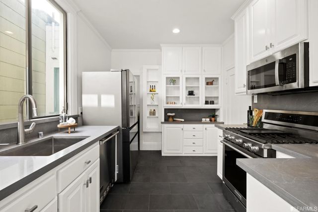 a kitchen with a sink stove and cabinets