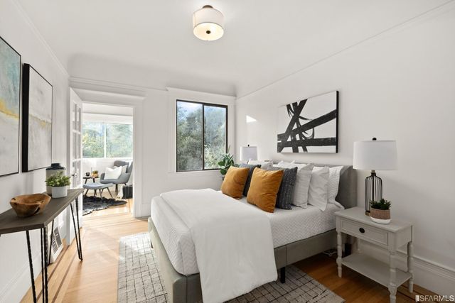 a bedroom with a bed and a large window