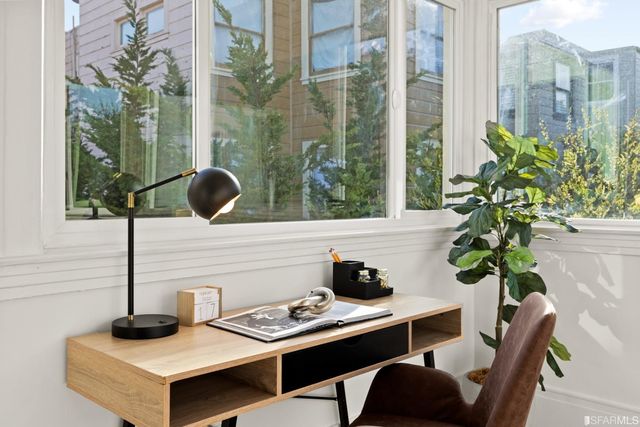 a view of a workspace with furniture and a potted plant