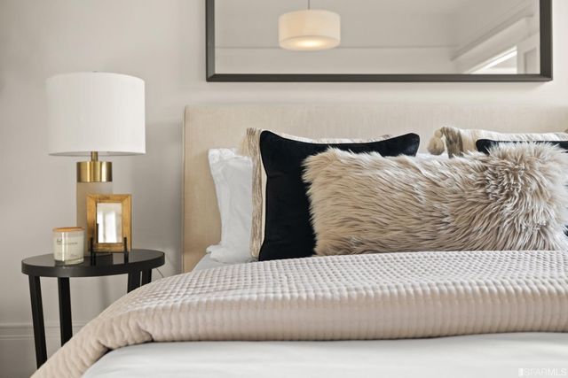 a bedroom with a bed and a lamp