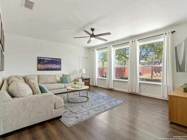 a living room with furniture and a large window