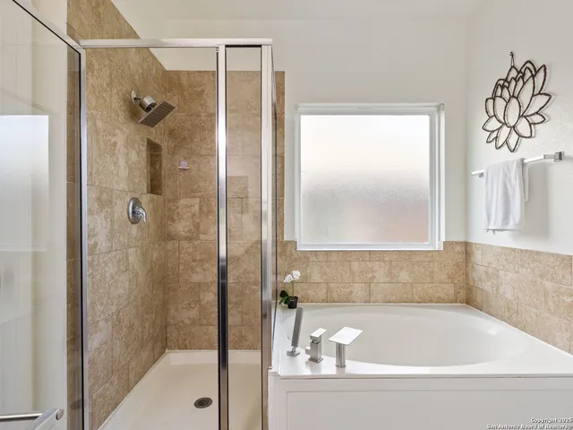 a bathroom with a bathtub and shower