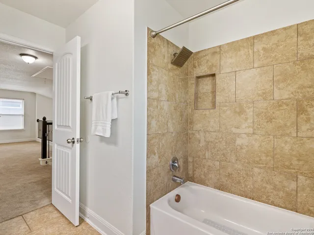 a bathroom with a shower a bathtub and a shower