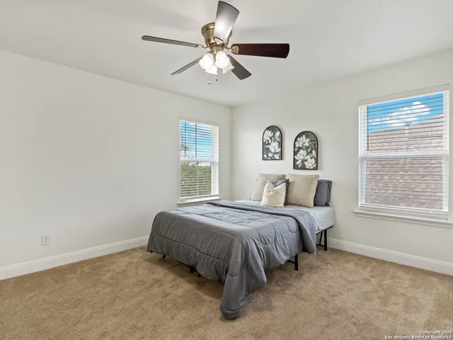 a spacious bedroom with a bed and a window
