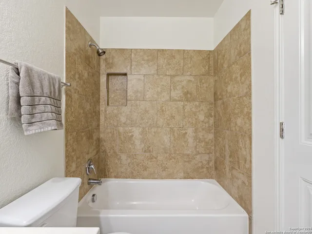 a bathroom with a bathtub and a toilet