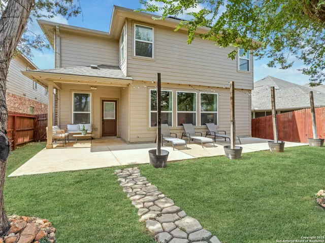 a view of a house with backyard porch and sitting area