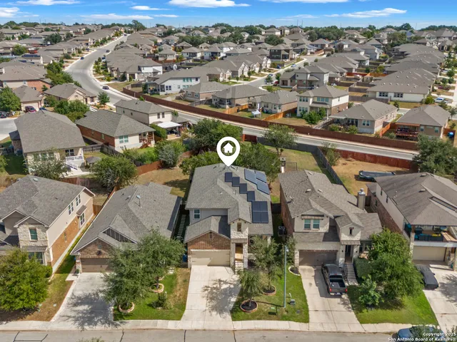 an aerial view of residential houses with outdoor space