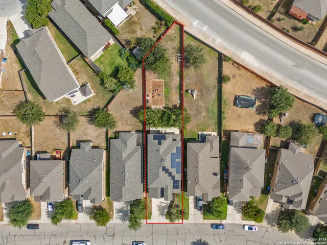 an aerial view of residential houses with outdoor space