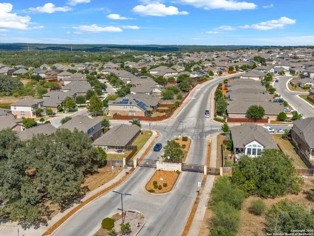 an aerial view of residential houses with outdoor space