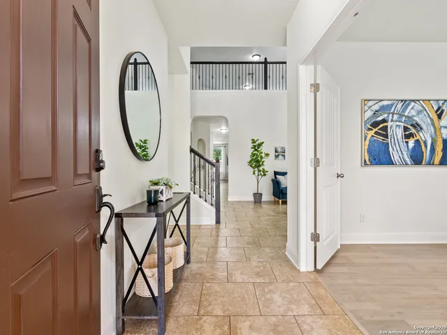 a view of a livingroom with furniture and a fan