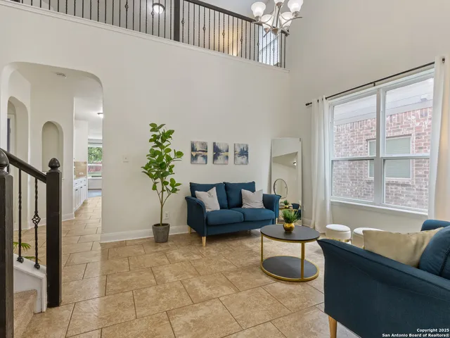 a living room with furniture and a large window