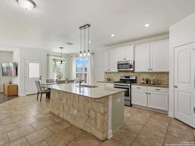 a large kitchen with white cabinets