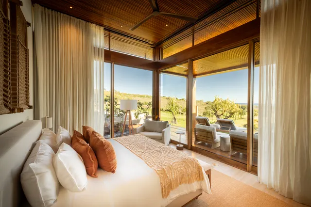 a bedroom with a large bed and a balcony view